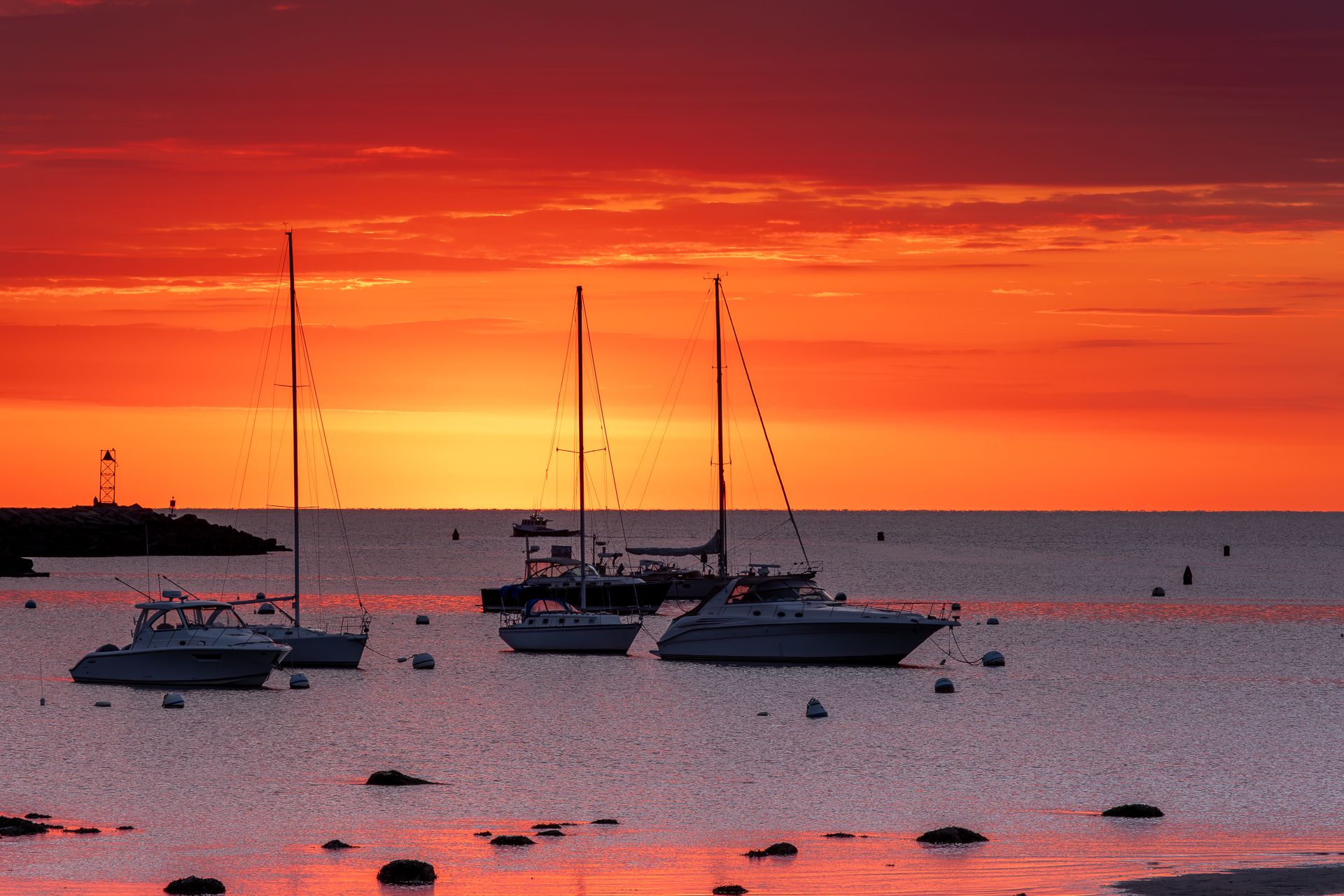 Boats on the water during sunrise in Scituate Harbor.