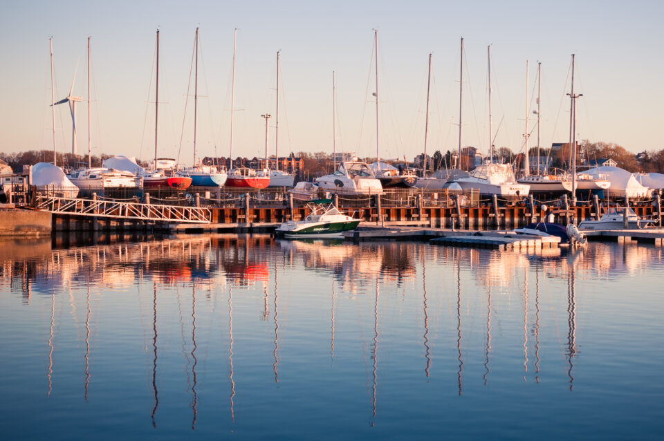 Colorful boats reflecting in the water at a marina in Hull, Massachusetts.