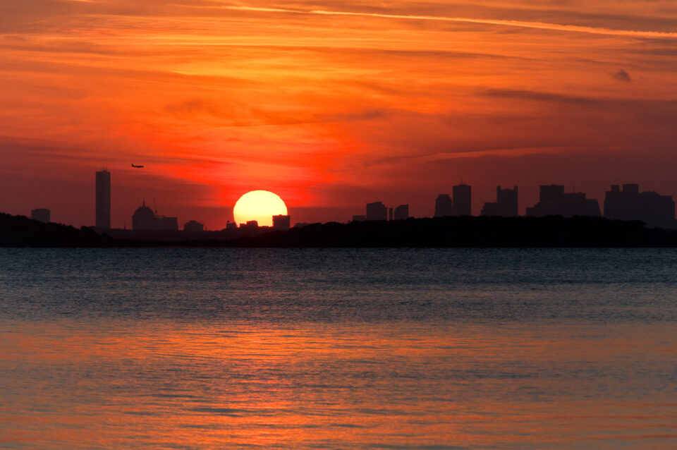 Vibrant hues over the Boston skyline during sunset, as seem from the Word's End in Hingham, Massachusetts.