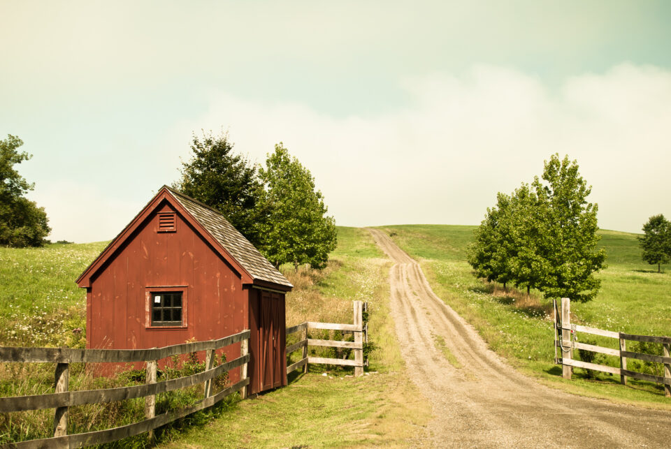 A red house at the bottom of a hill in the New York Berkshires.