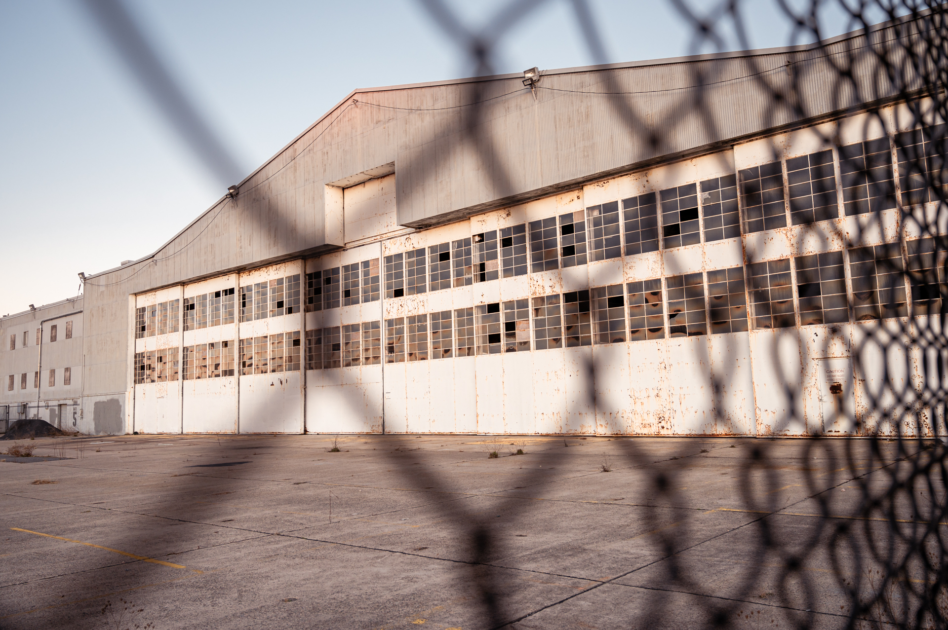 A hangar seem through a fence.