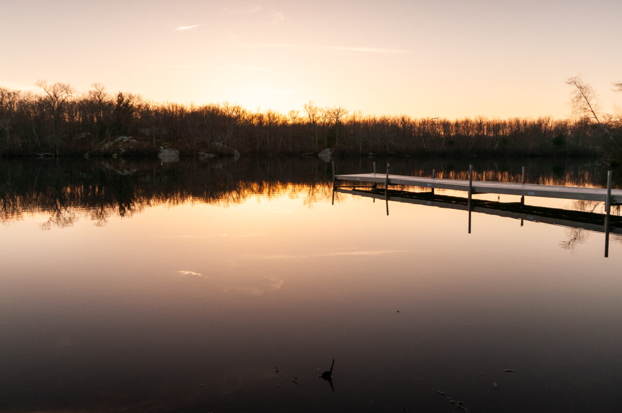 A boat dock at Ames Nowell State Park during sunset.