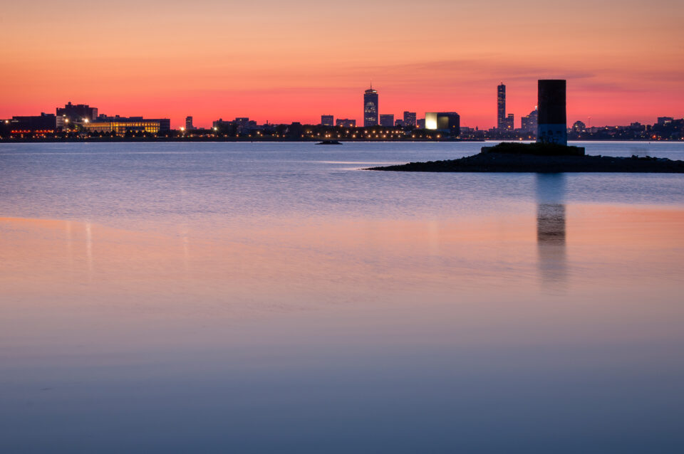 Colorful skies at sunset over the Boston skyline, as seen from Squantum in Quincy, Massachusetts.