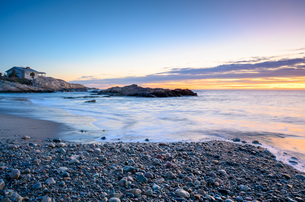 A view of the rocky shore at Minot Beach during sunrise.