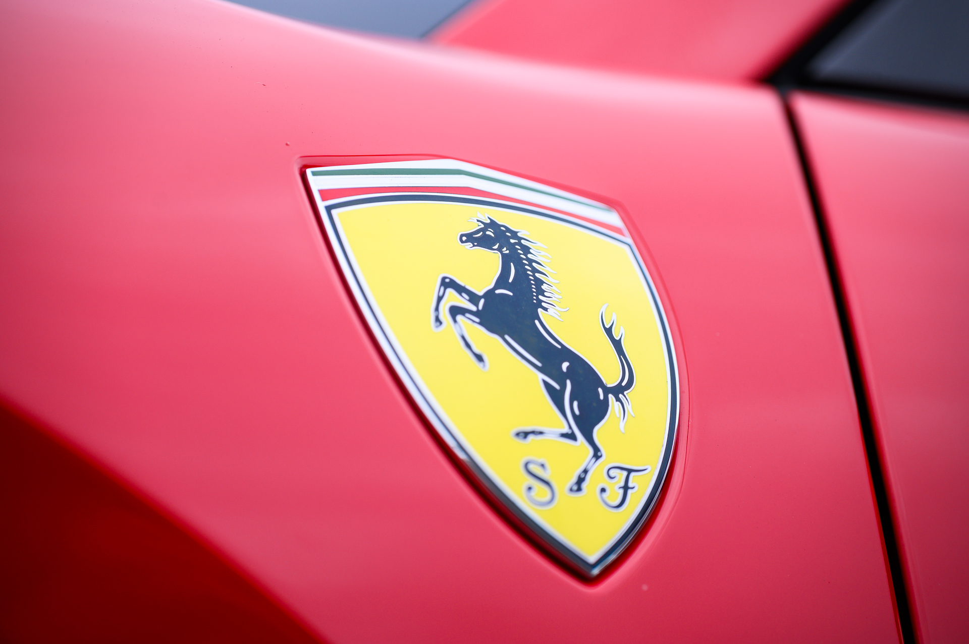 A close up of a Ferrari logo at the Boch Exotics Cars and Coffee car show.