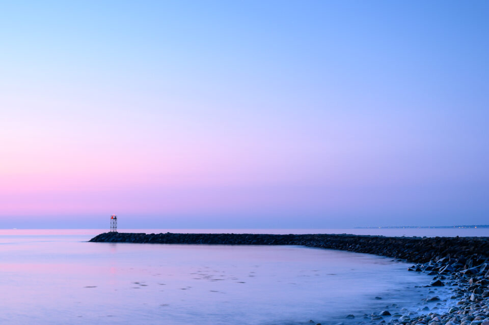 A long exposure of the Scituate Breakwater near Old Scituate Lighthouse during sunrise in Scituate, Massachusetts.