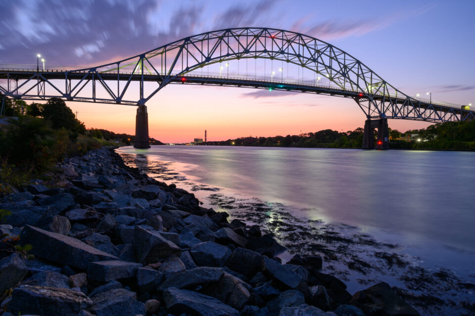 Soft hues during sunrise over the Sagamore Bridge in Bourne, Massachusetts.