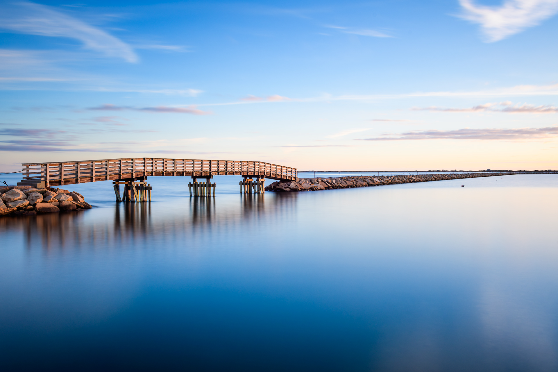 A long exposure of the Plymouth Jetty at Plymouth Harbor shortly after sunrise.