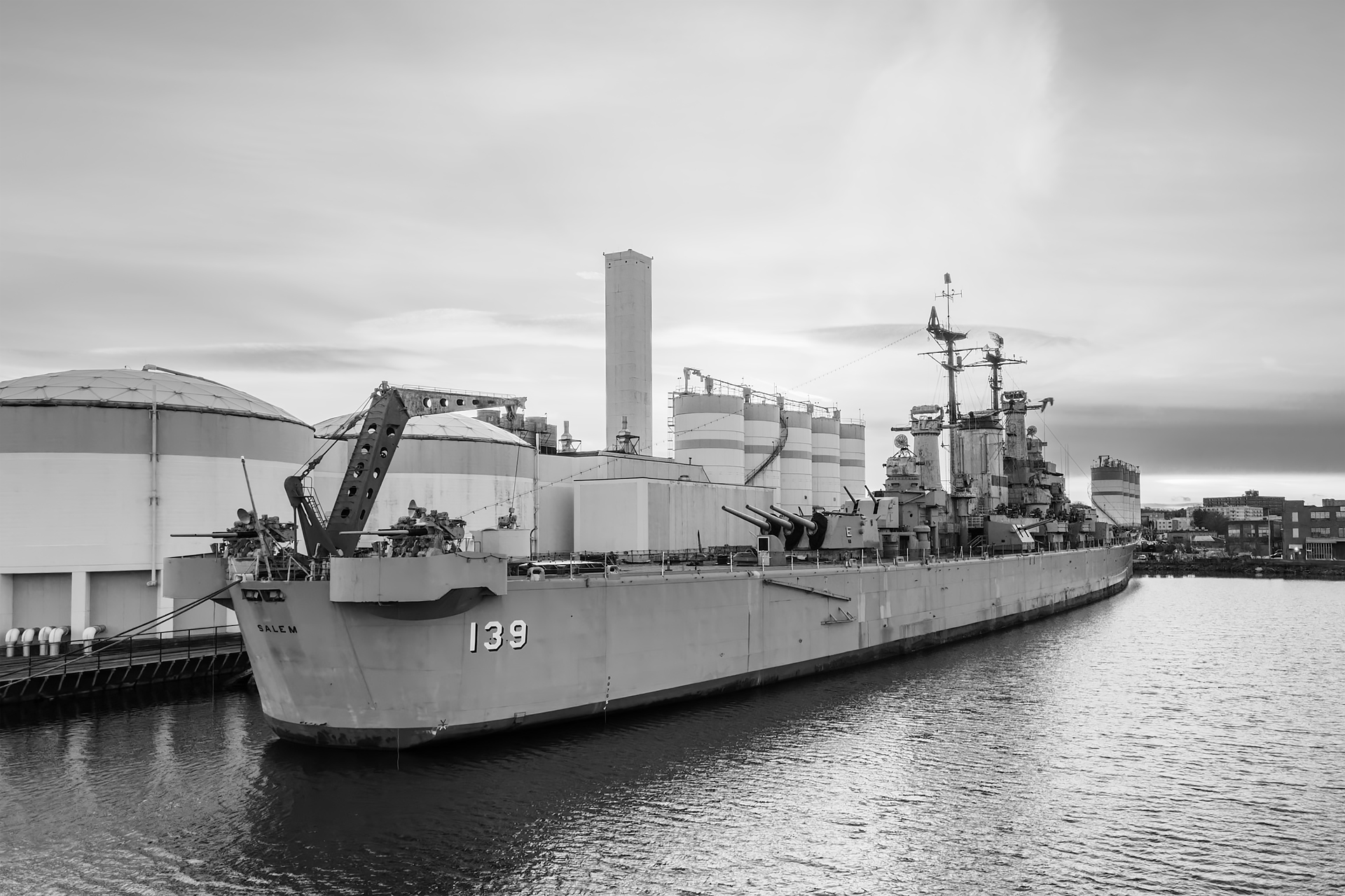 An aerial view of the USS Salem (CA-139) resting proudly at the Quincy Shipyard in Massachusetts.