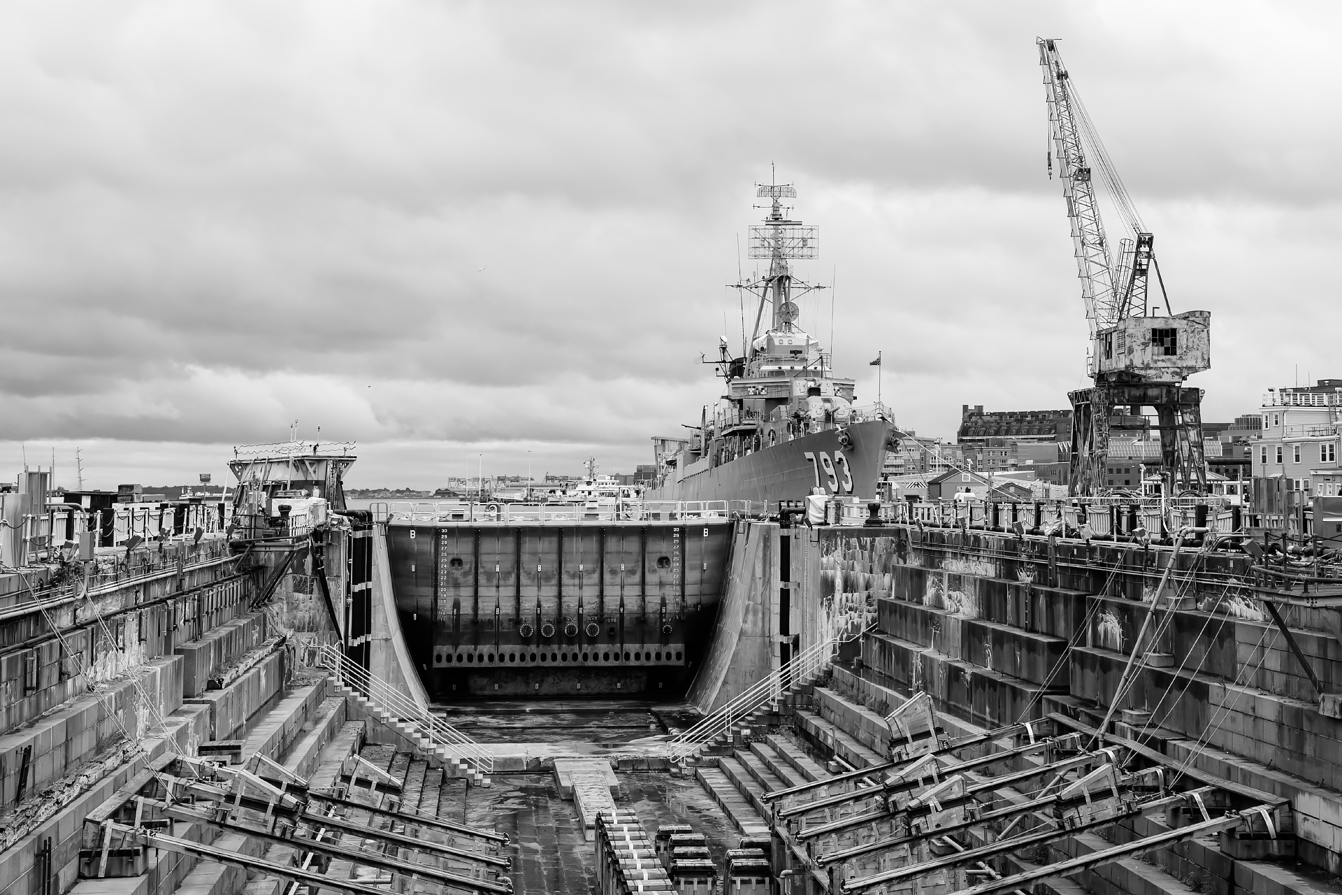 The granite dry dock, with the USS Cassin Young in the background, at the Charlestown Navy Yard in Boston, Massachusetts.