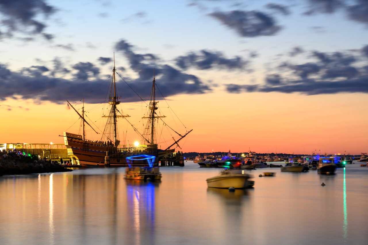 The Mayflower II docked at Plymouth Harbor at sunset on the Fourth of July.
