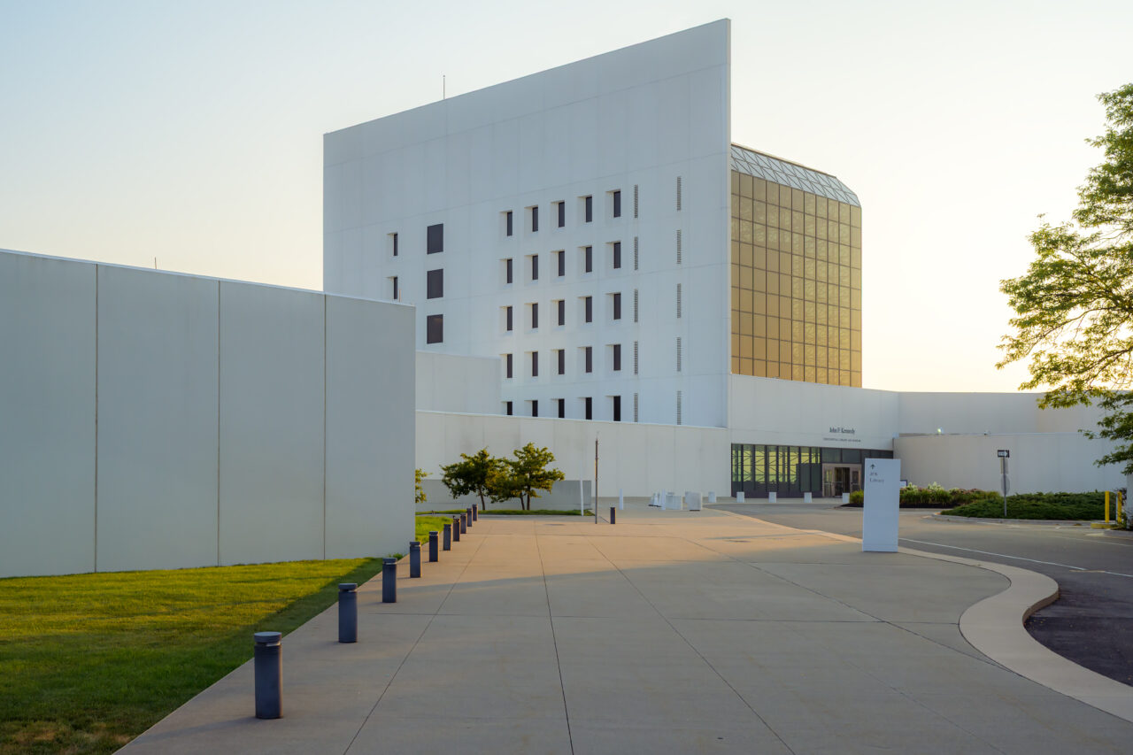 A view of the front entrance of the JFK Library and Museum in Boston during sunrise.