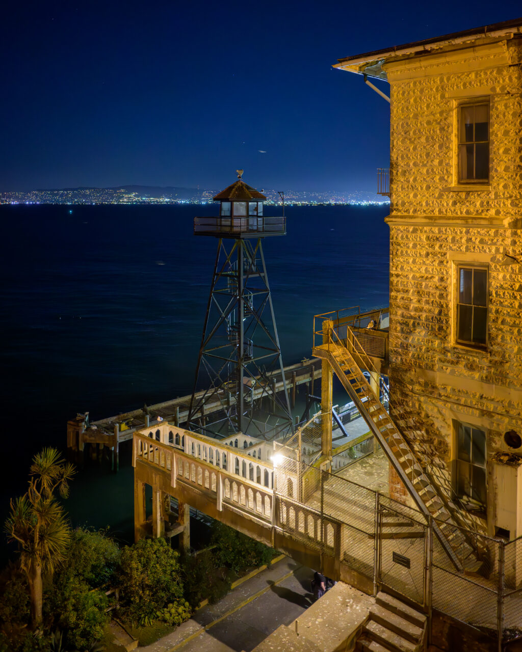 The guard tower at Alcatraz overlooking the bay with the city set in the distance.