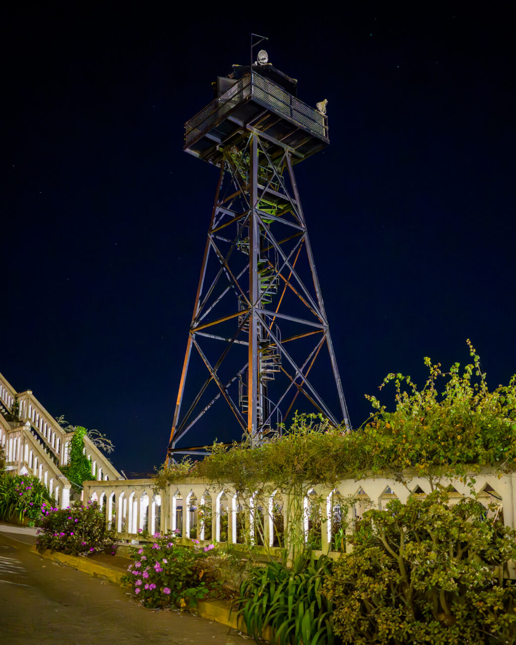 A close up view of the guard tower at Alcatraz set against the night sky.