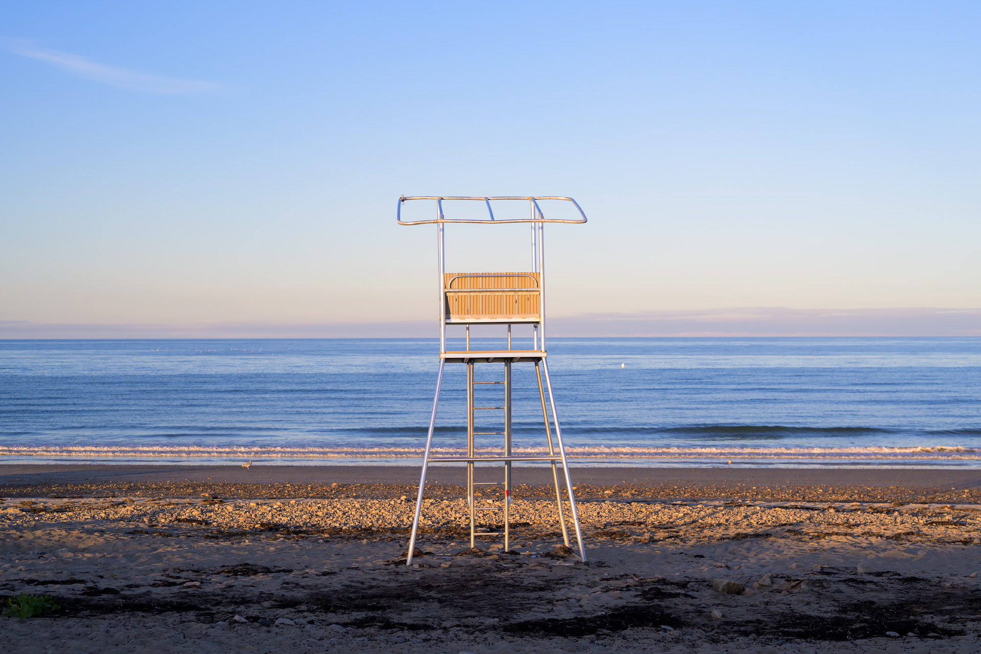 Empty lifeguard stand watching over Duxbury Beach at sunset.