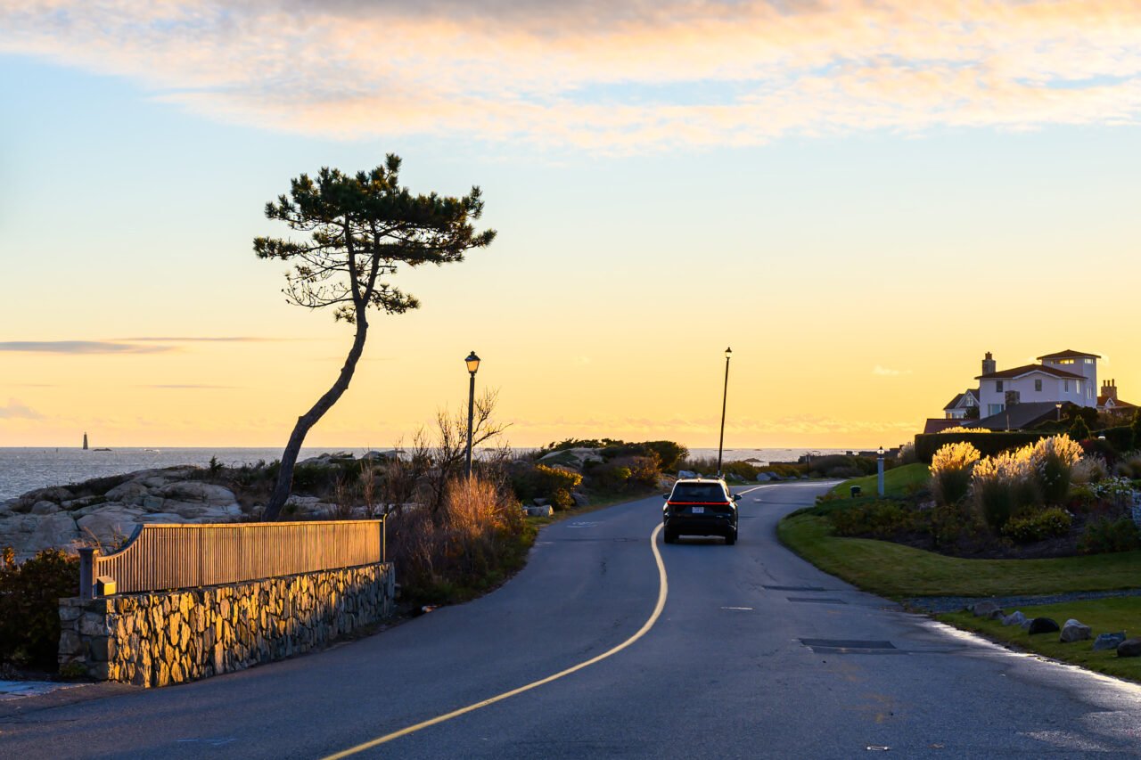 A car heads down Jerusalem Road in Cohasset before sunrise.