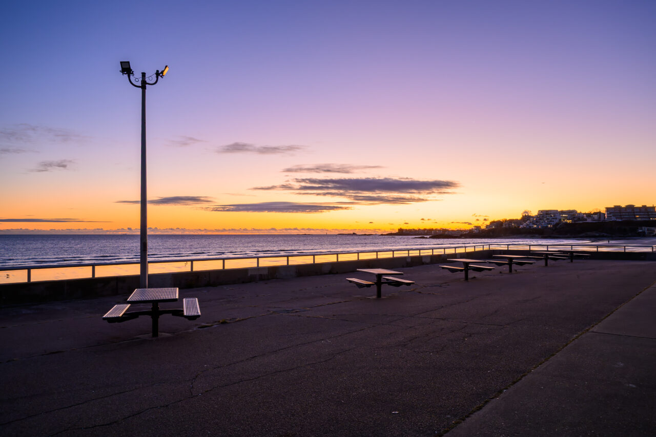 Picnic benches along Nantasket Beach at first light.