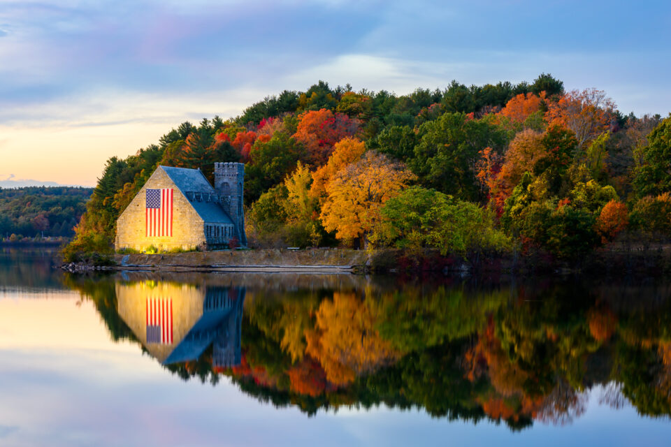 Autumn at the Old Stone Church, with its bell tower and ruins framed by colorful foliage, overlooking the Wachusett Reservoir.