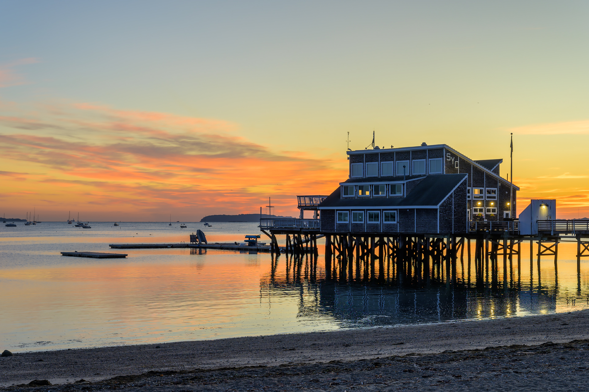 The Quincy Yacht Club during a colorful sunrise at Wollaston Beach.