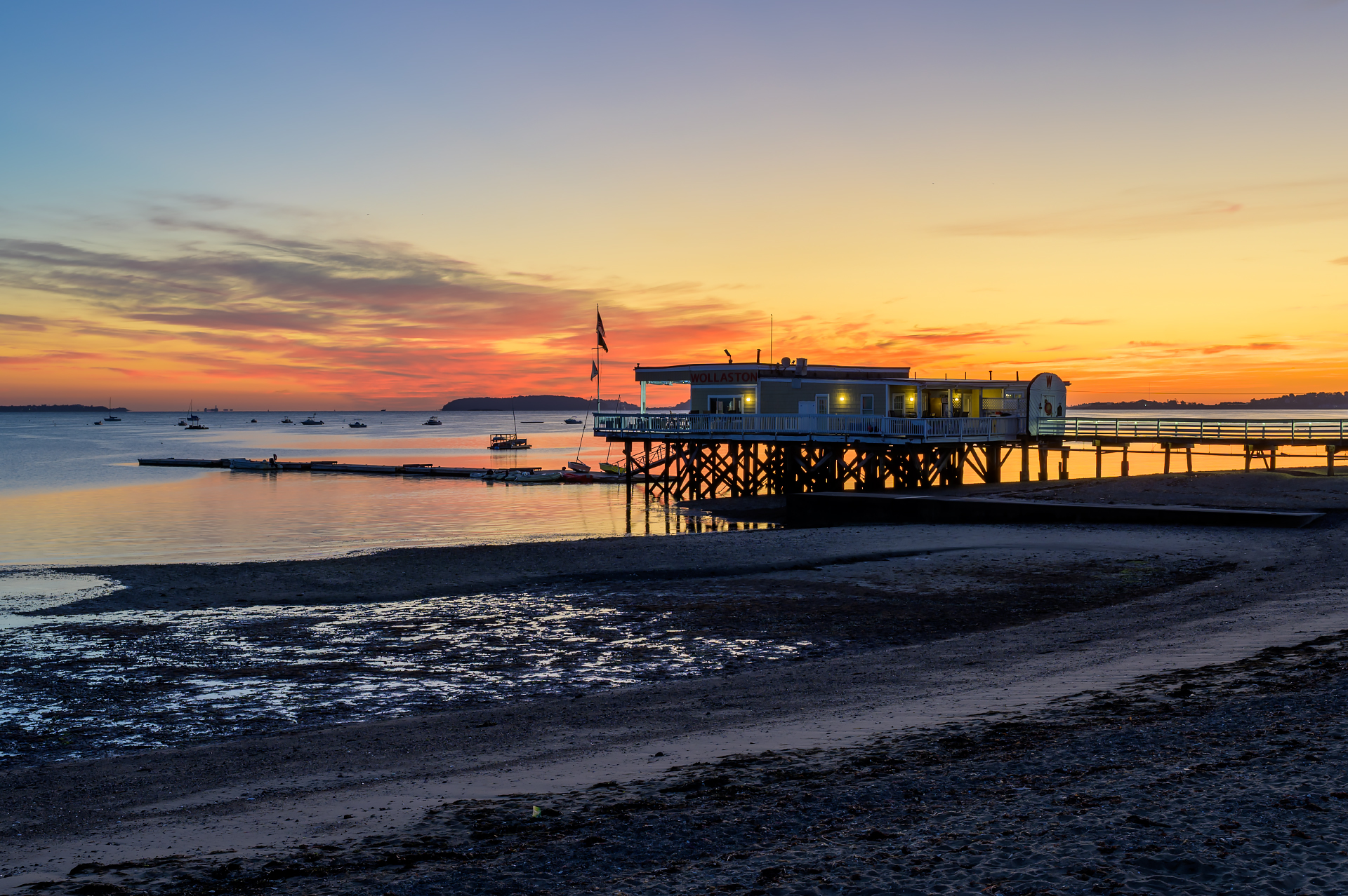 The Wollaston Yacht Club during a colorful sunrise at Wollaston Beach in Quincy.