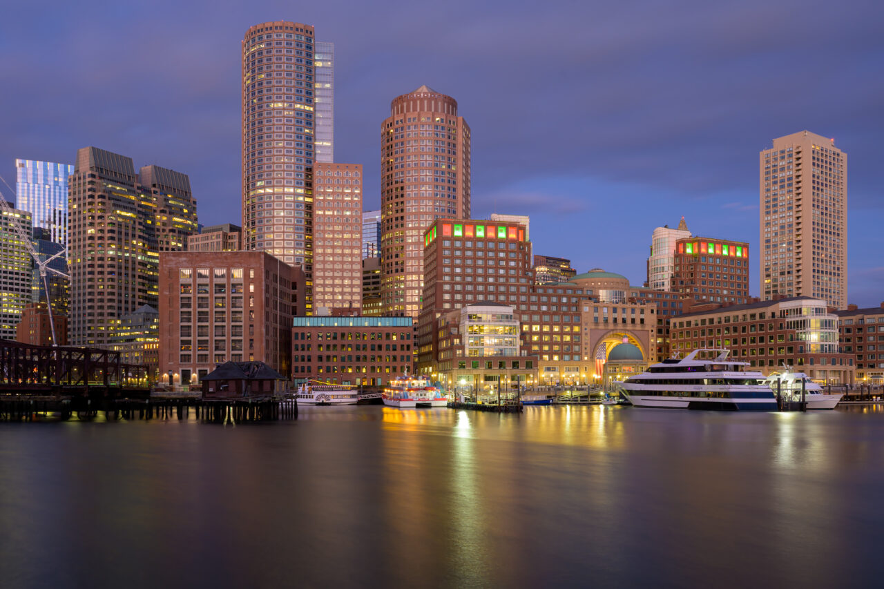 A peaceful dawn view of the Boston harbor captured with a long exposure as the sky begins to brighten.