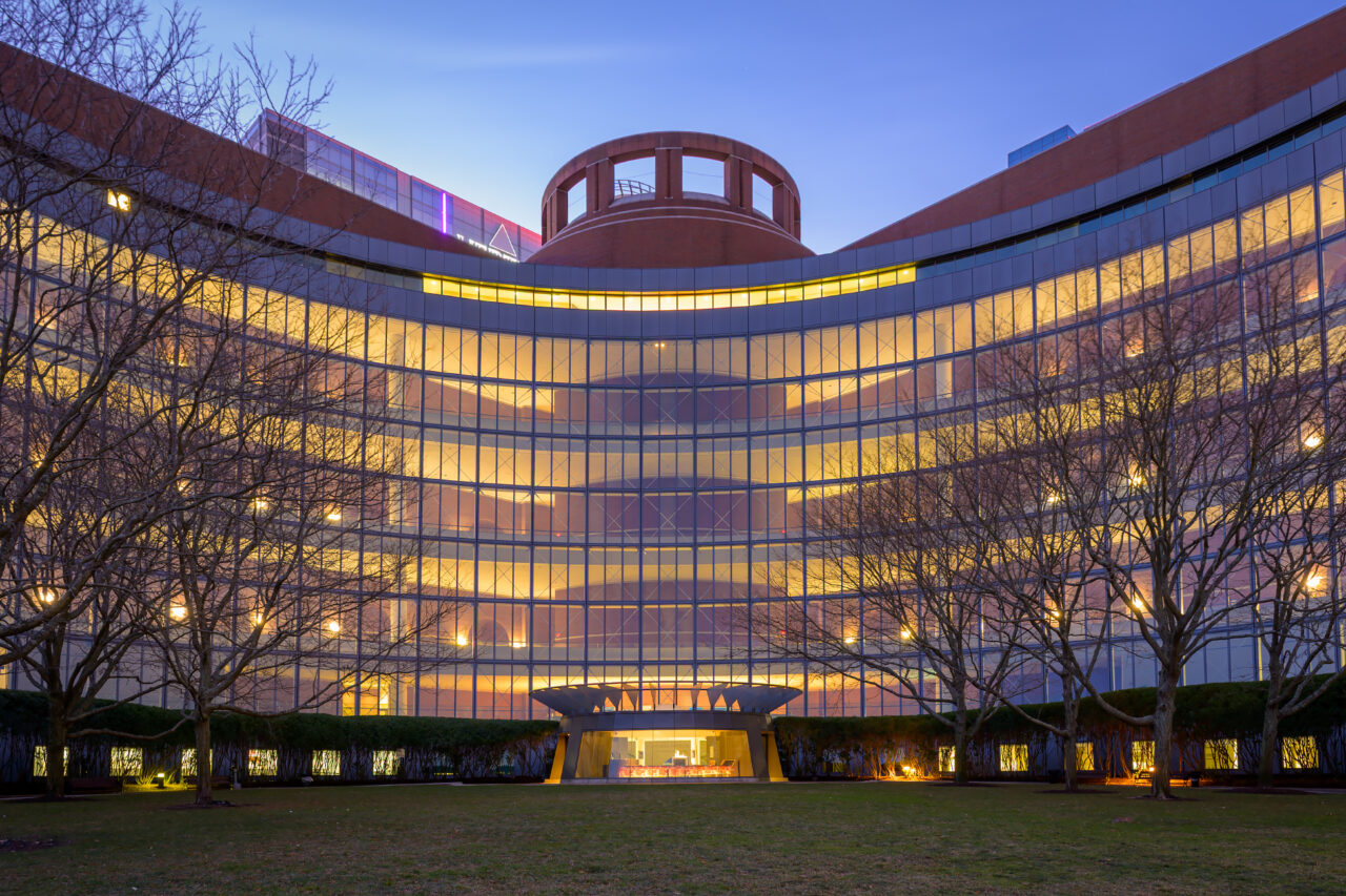 The brick and glass exterior of the Moakley Courthouse in the Seaport District, captured in the quiet light of dawn.