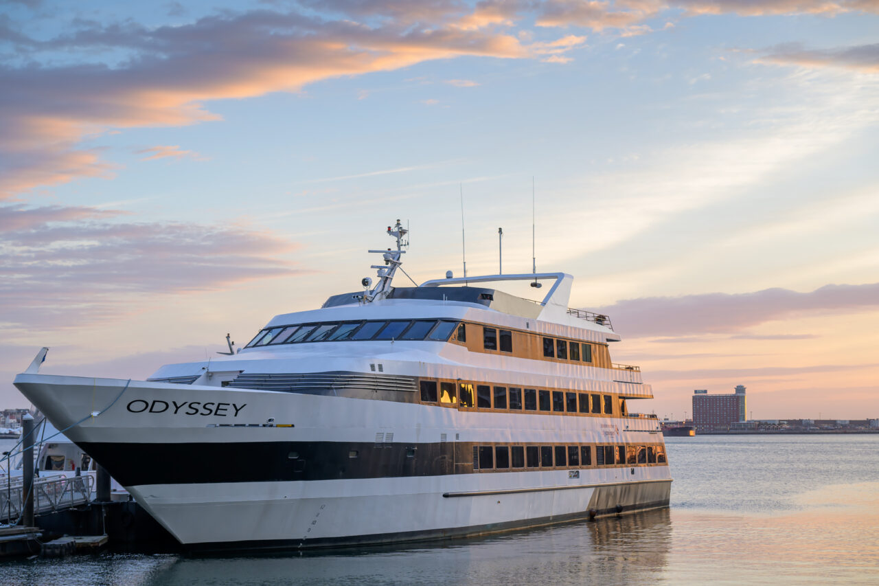 The Odyssey cruise ship docked in Boston Harbor during a winter solstice sunrise.
