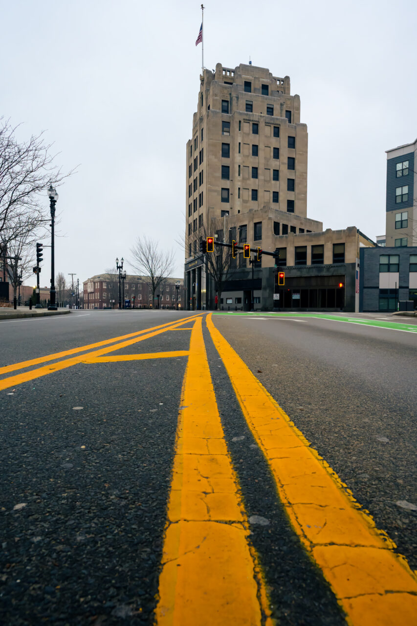 Early Hours in Quincy Center captured at street level with empty roads and double yellow lines leading to the Bank of America building.