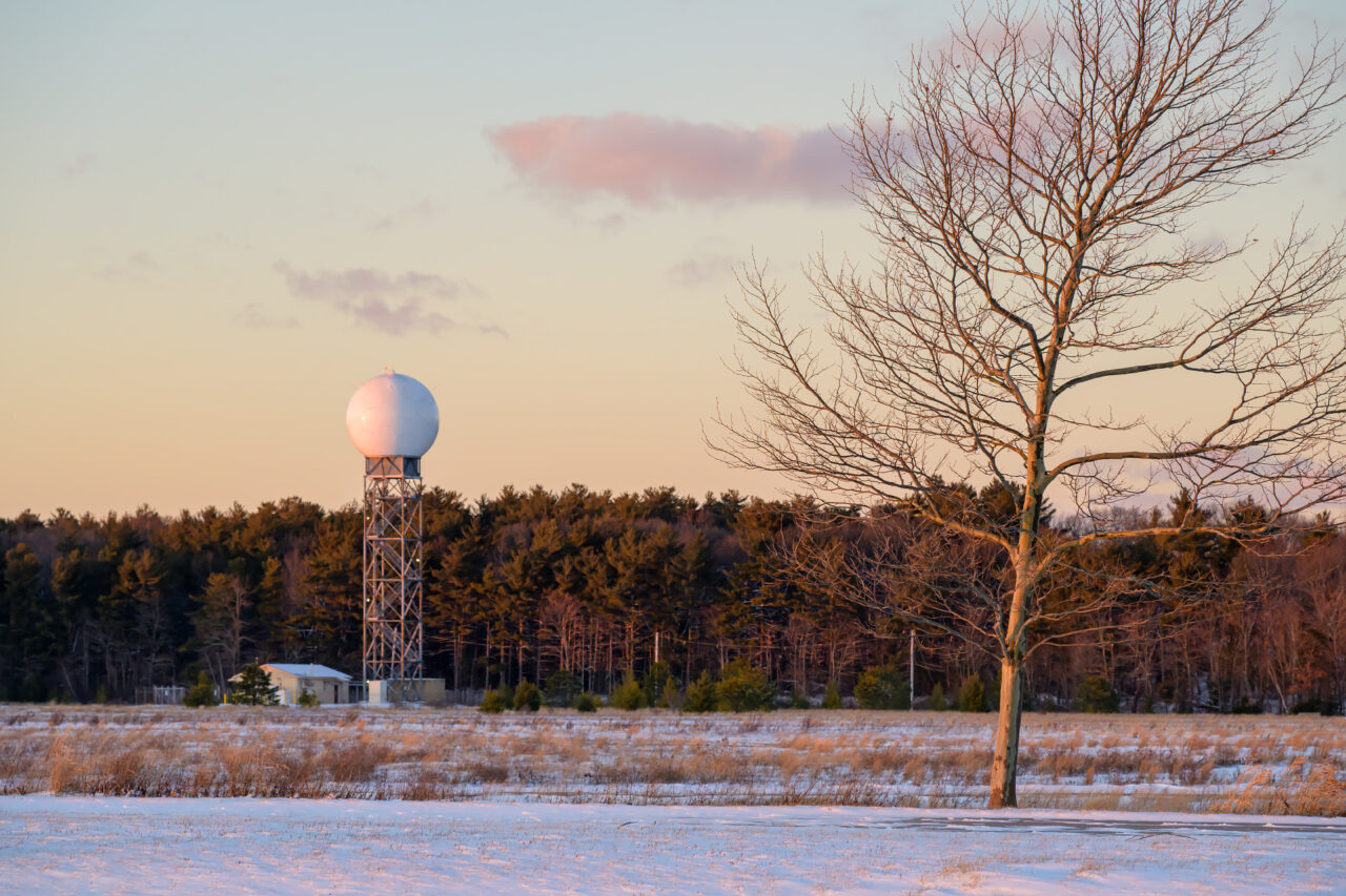 A white radar dome at the former South Weymouth Naval Air Station at sunset.