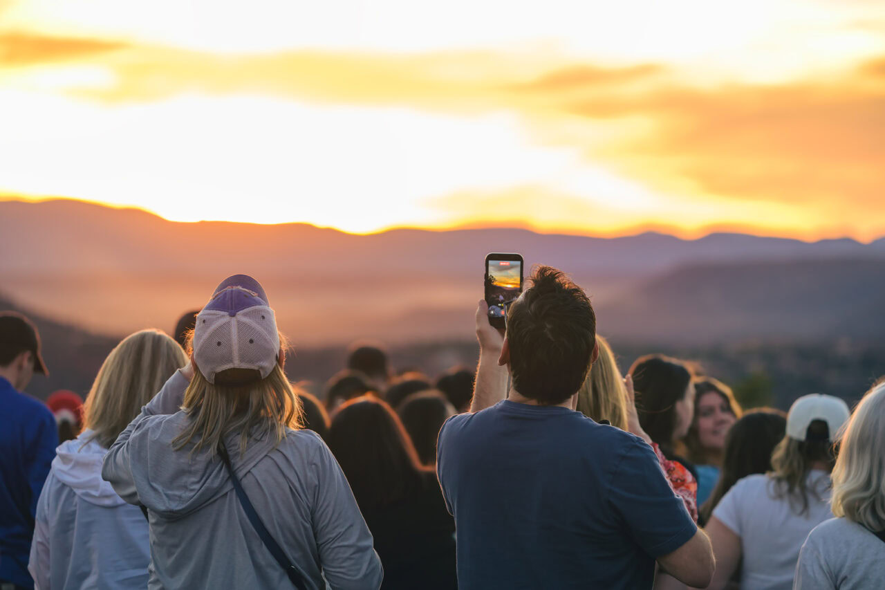 A friendly crowd gathered at Airport Mesa in Sedona to photograph the brilliant orange sunset.