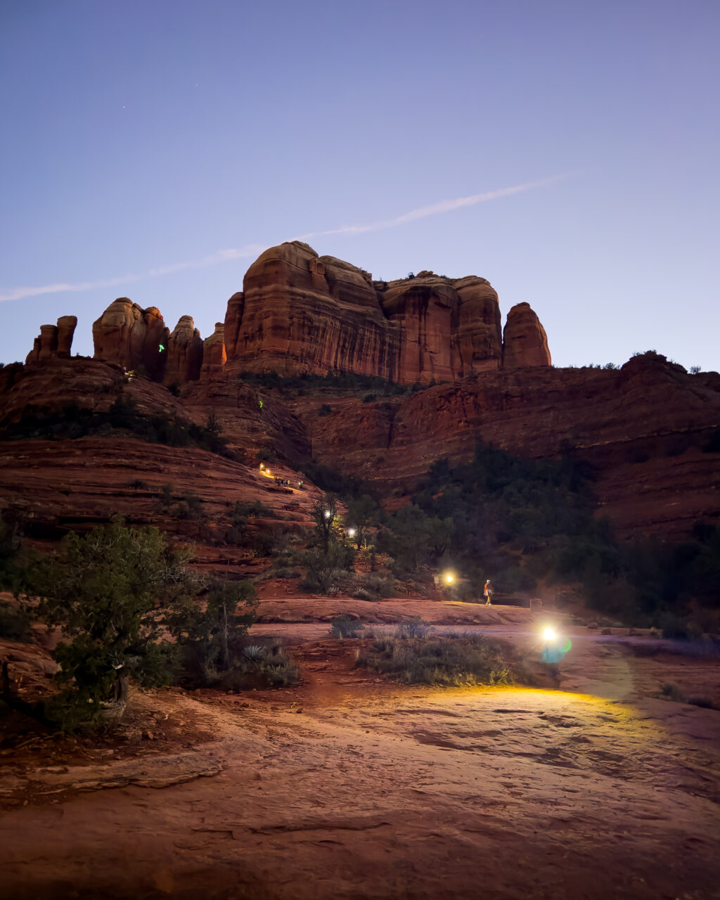 Cathedral Rock at dusk with hikers descending the trail, Sedona Arizona.