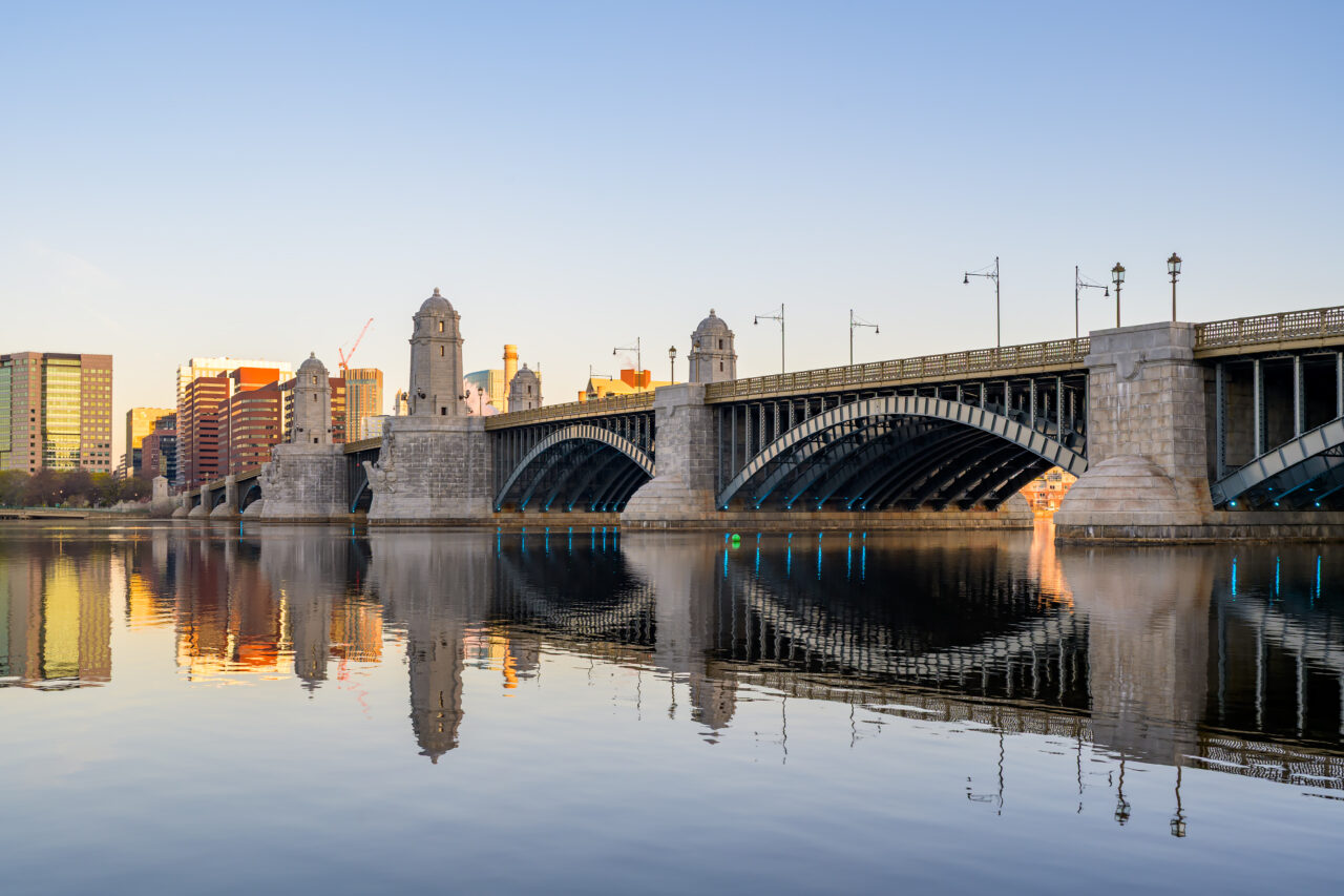 Wide view of the Longfellow Bridge arches from the Cambridge side of the Charles River.