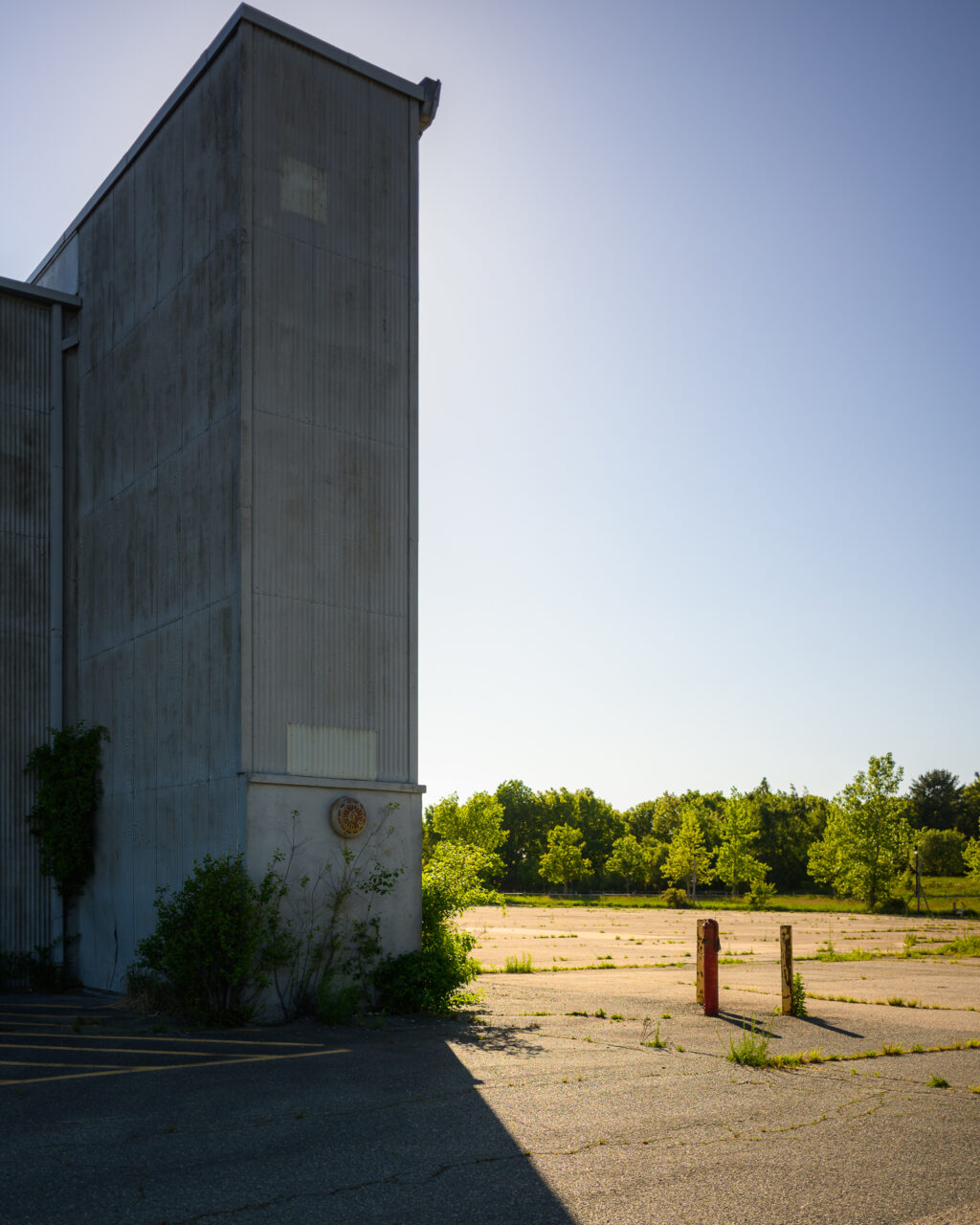 Corner of an abandoned hangar at South Weymouth Naval Air Station in afternoon light.