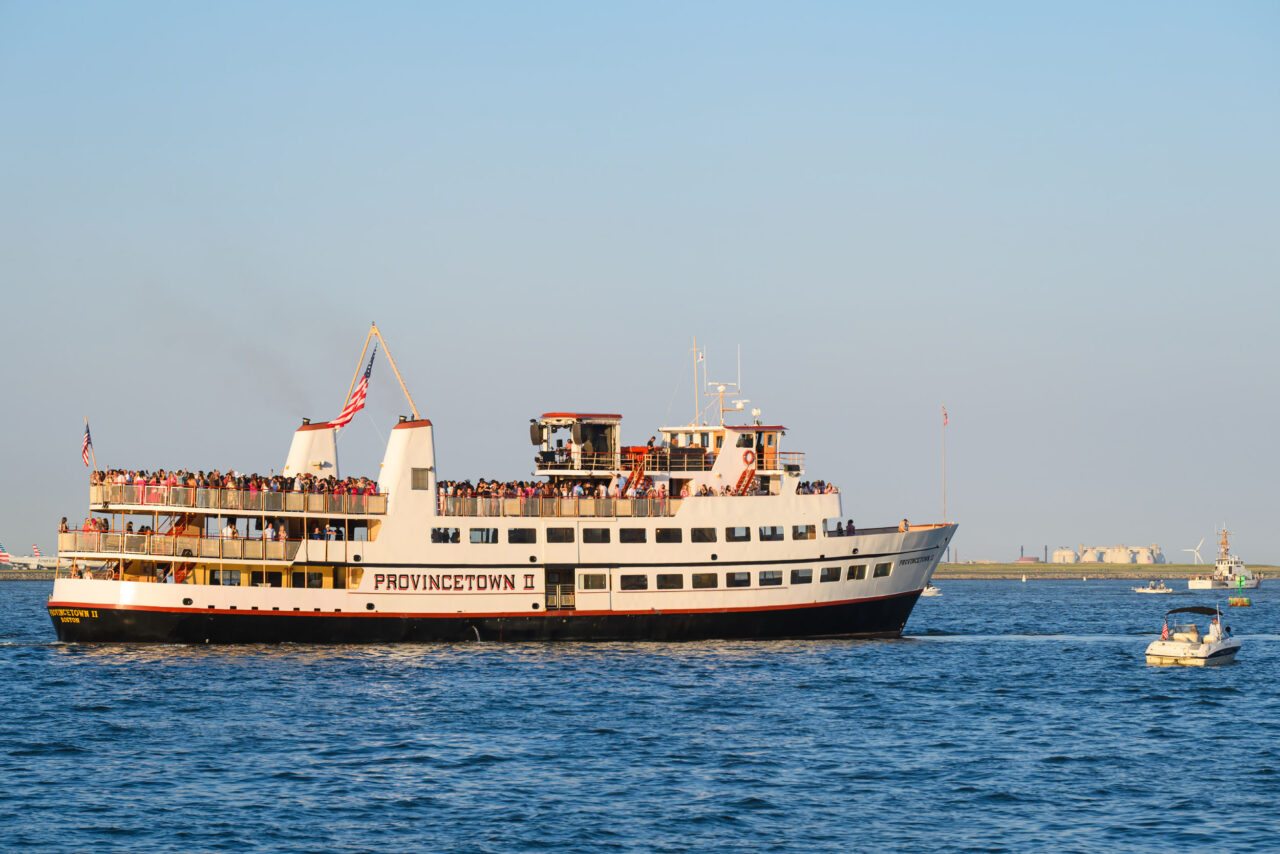 Provincetown II ferry traveling through Boston Harbor at sunset.