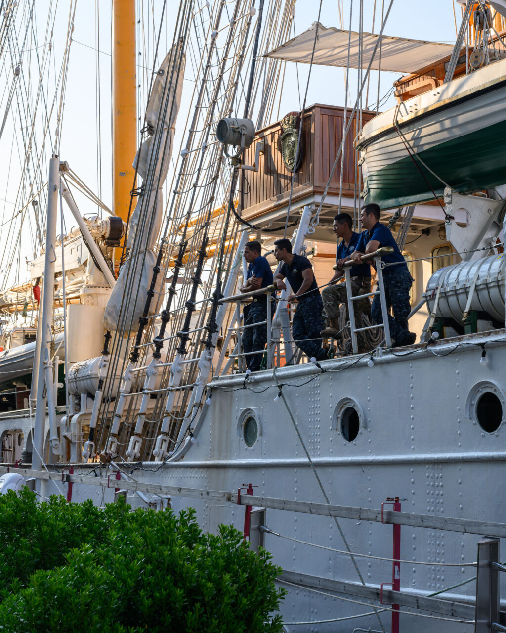 Crew members standing aboard Chile's Esmeralda during Sail Boston 2026.